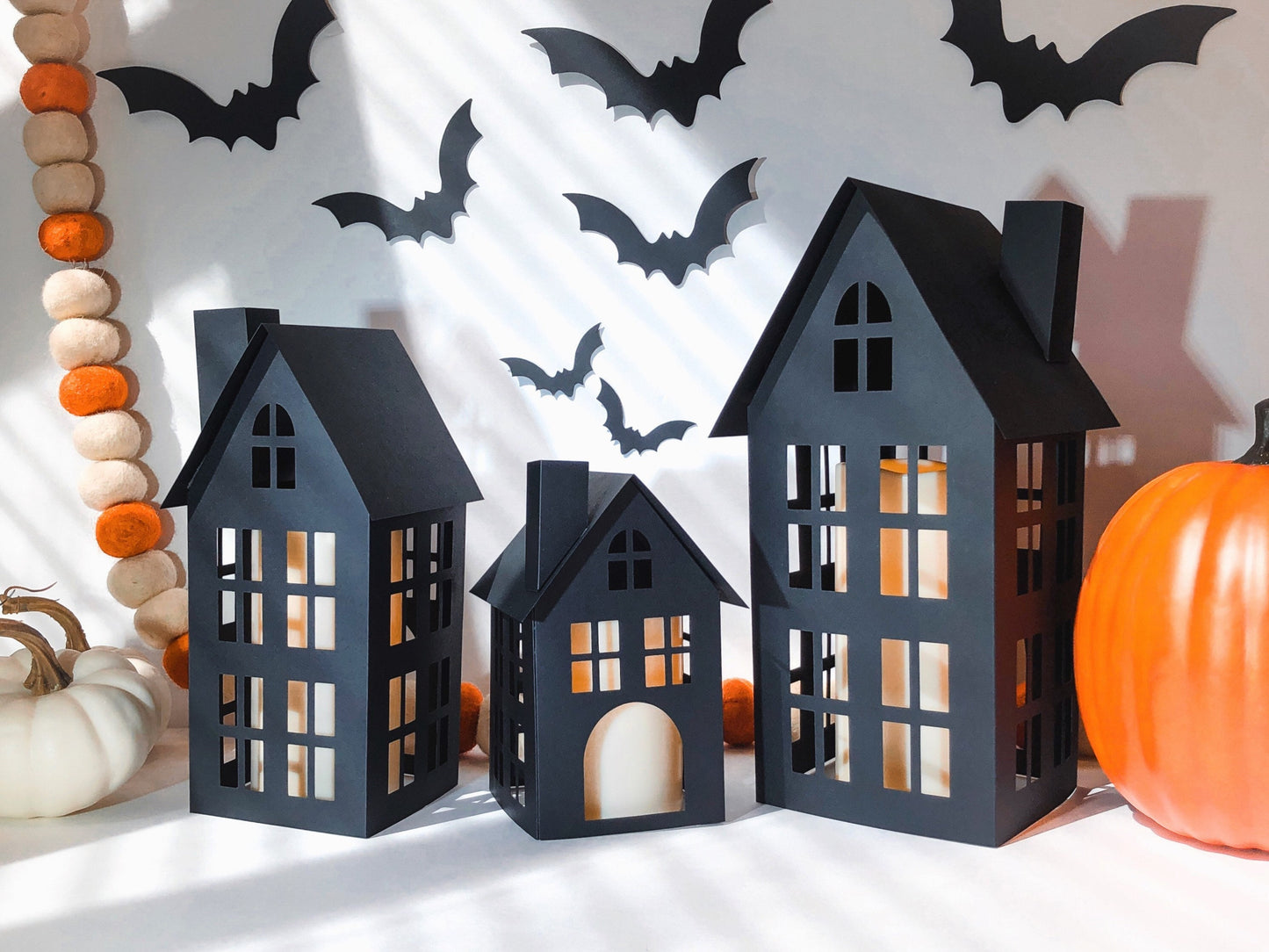 DIY Paper Halloween Village with Bats, Easy DIY kit for kids and families to add to Halloween decor by making three black paper houses to put LED candles in.