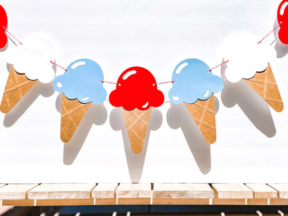 Set of seven paper ice cream cones with white, blue and bright red ice cream scoops on top of a layered Kraft paper cone all on a red & white baker's twine string.